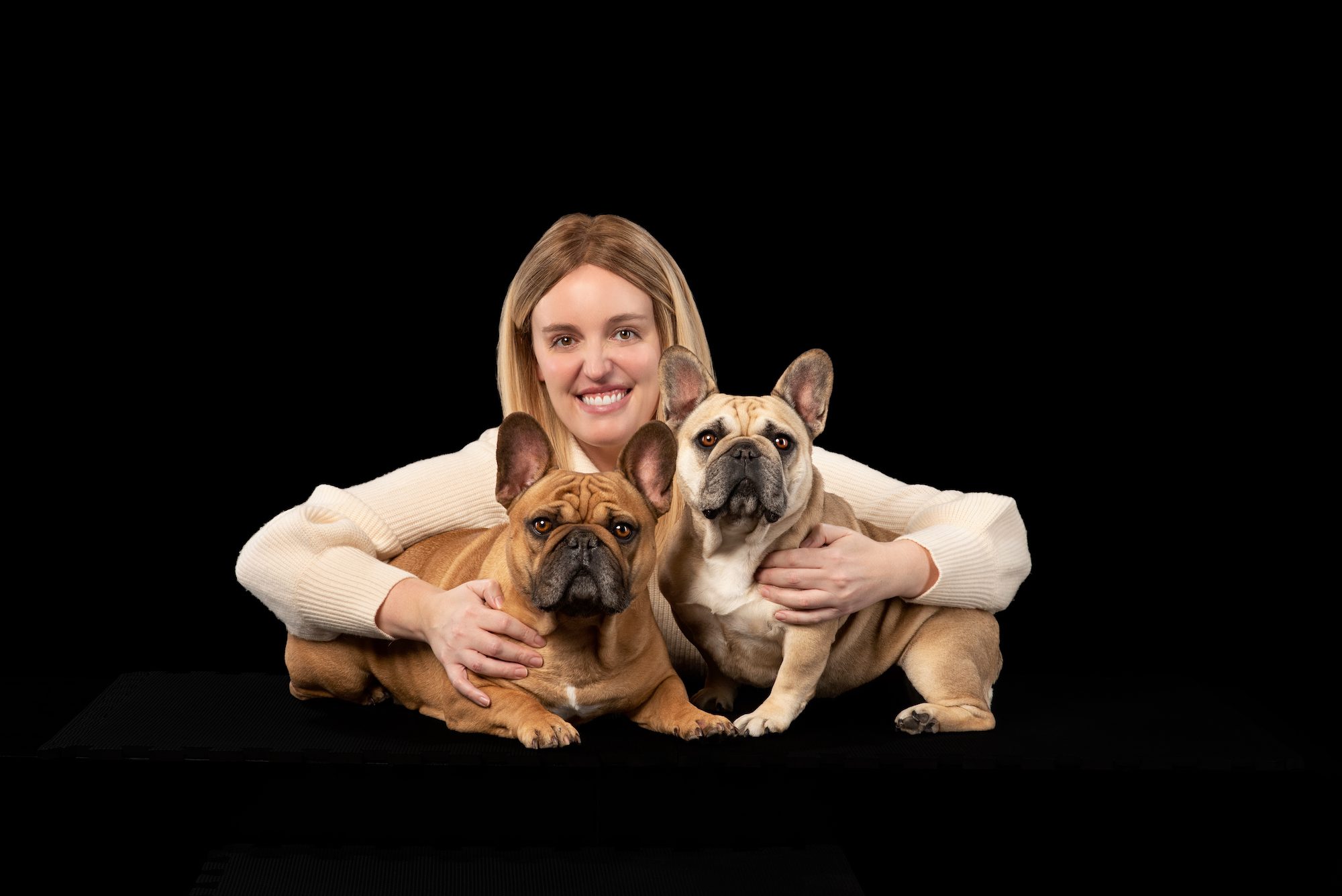 Blonde woman with two french bulldogs portrait