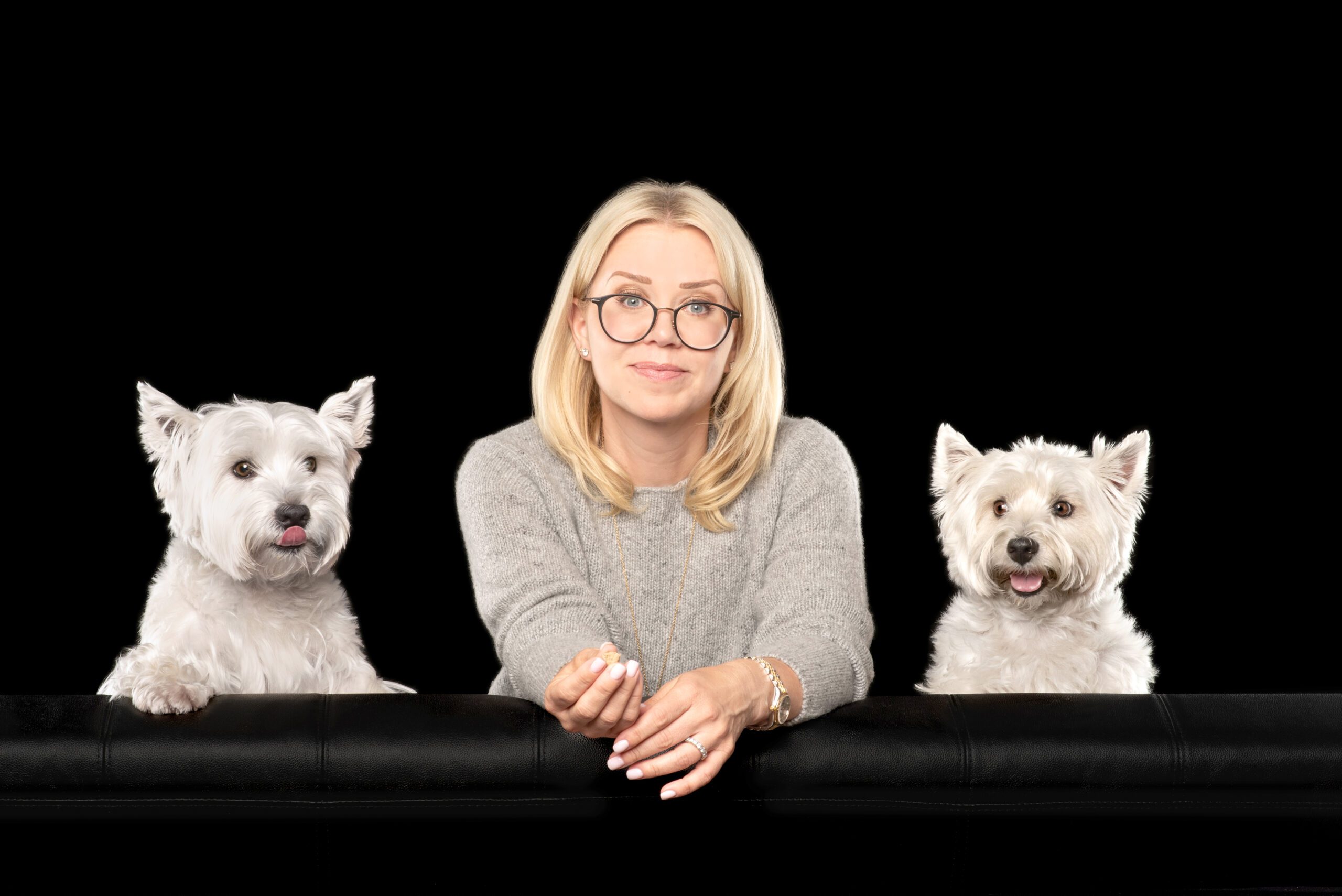 Two westie pups with their owner