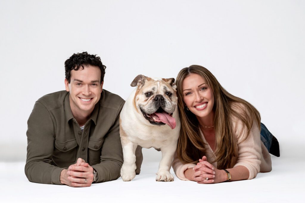 Family portrait with their English Bulldog, Tuna, photographed in a Chicago pet photography studio.